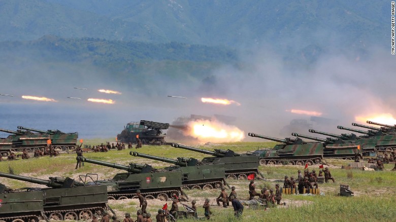 Photo released by North Korea's official Korean Central News Agency shows rockets being launched by Korean People's Army (KPA) personnel during a target strike exercise at an undisclosed location in North Korea. 