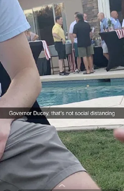 photo of Arizona Governor Doug Ducey at a backyard barbecue party June 12th, where neither he or any of the other guests are wearing masks or social distancing